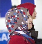 Two women in colorful headscarves